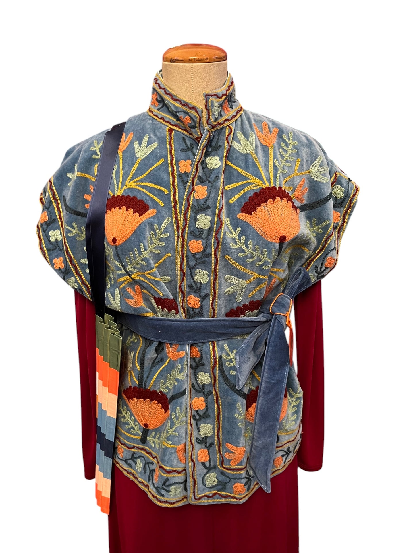 Long bordeaux nylon dress with Suzani velvet vest and Multitudes bag